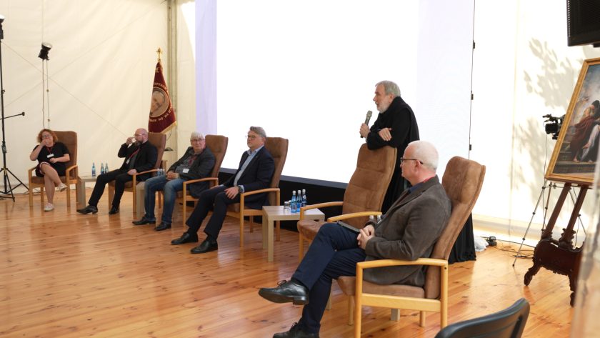 Szeroki plan na panel dyskusyjny z udziałem ekspertów i zakonników – konferencja odbywa się w namiocie konferencyjnym.