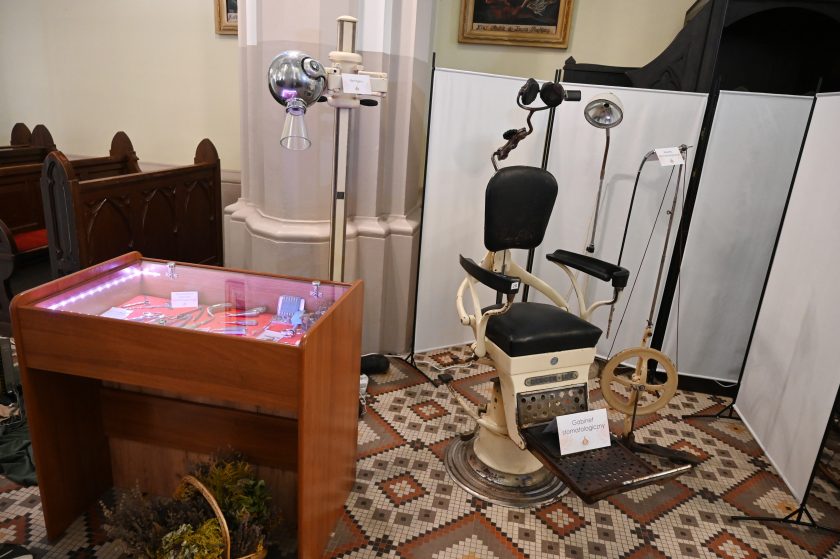 Ekspozycja dawnego gabinetu stomatologicznego – zabytkowy fotel dentystyczny, lampy i narzędzia medyczne w gablocie