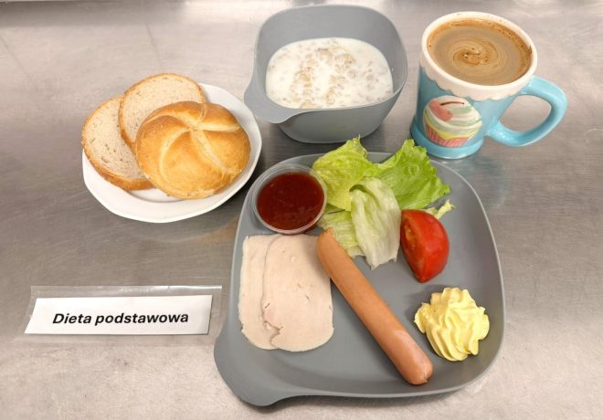 Śniadanie w diecie podstawowej: pieczywo pszenne, parówka i wędlina drobiowa z dodatkiem sałaty i pomidora, odrobina majonezu oraz sos pomidorowy. Do tego mleczna owsianka i kubek kawy z mlekiem. Zestaw zapewniający energię na cały poranek – lekki, a zarazem pożywny