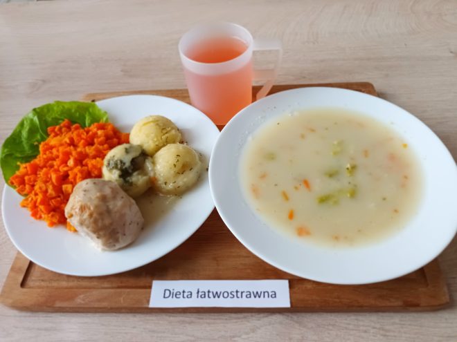Obiad w diecie łatwostrawnej: zupa jarzynowa oraz drugie danie składające się z gotowanych ziemniaków, pulpecika drobiowego i surówki z marchwi. Do posiłku kompot